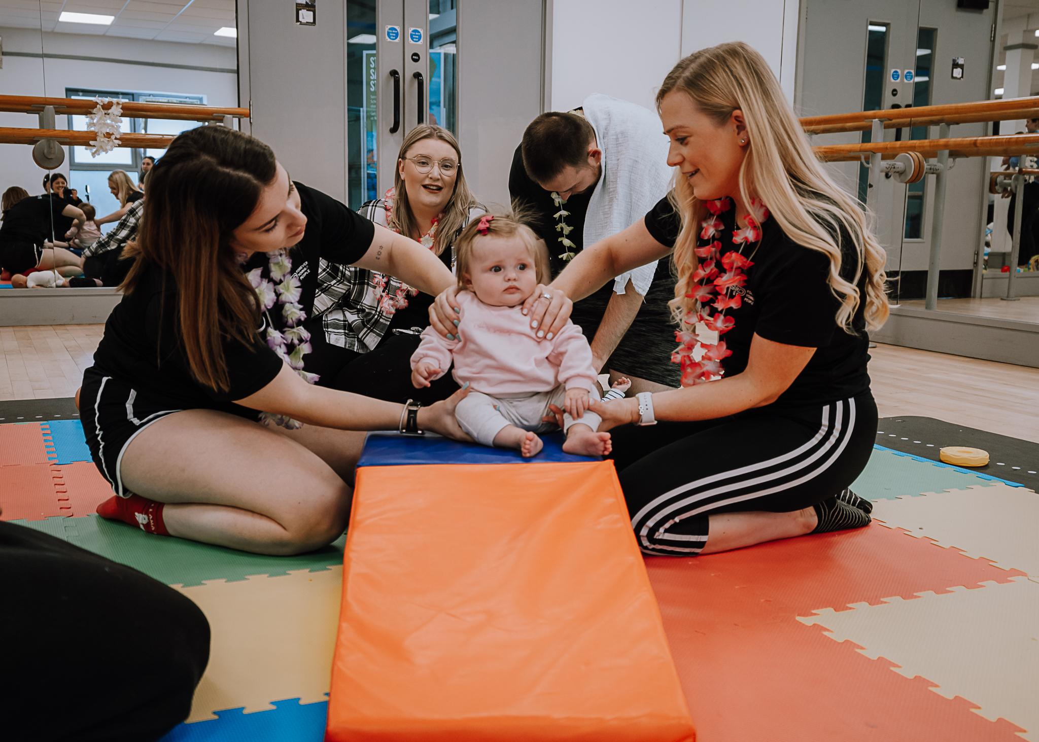 Dots mum and baby class event run by Forever Young People showing a little girl playing on mats