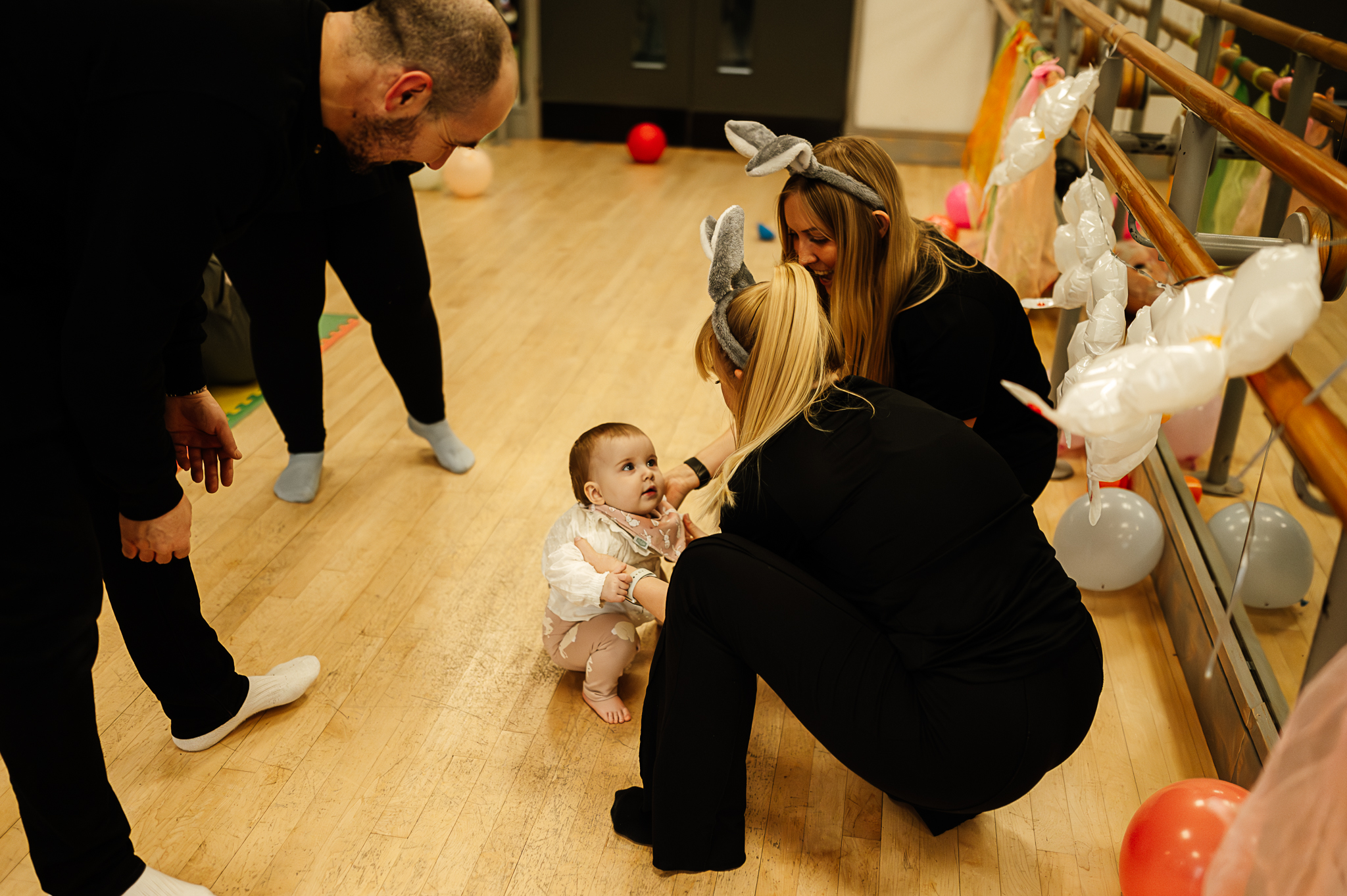 Non-Movers Dots mum and baby class run by Forever Young People showing a small child being helped by a teacher